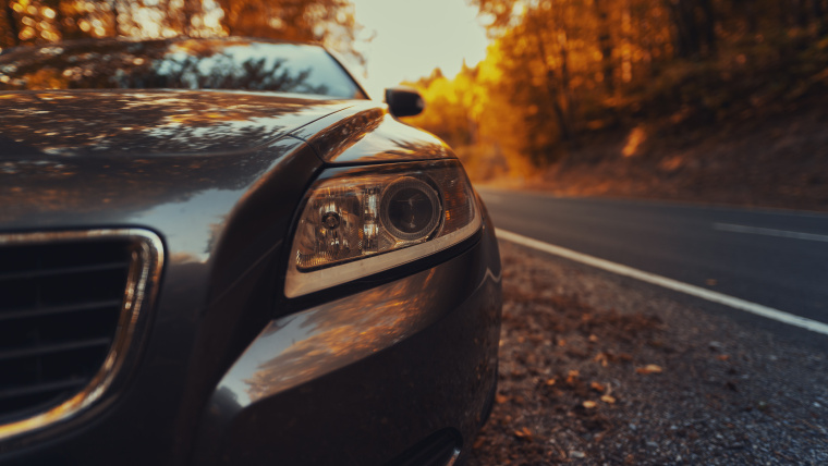 car parked in autumn leaves